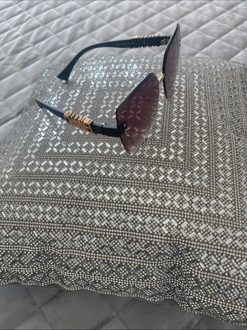 CHANEL Black Frames with Gold Trim and Burgundy Lenses Accent Pillow Display